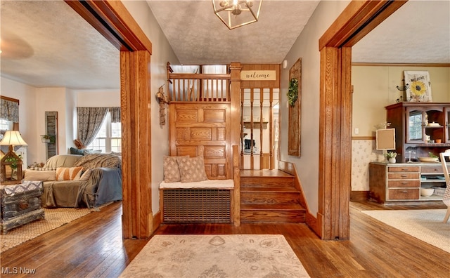 foyer featuring hardwood / wood-style flooring and a textured ceiling