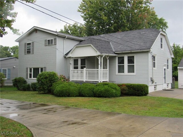 39007 Johnnycake Ridge Rd, Willoughby, OH 44094 - view of front of house featuring a porch, a front lawn, and roof with shingles