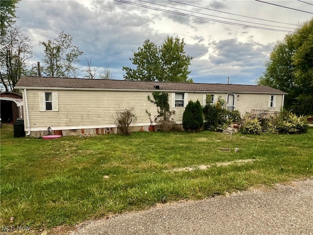 rear view of property featuring a lawn