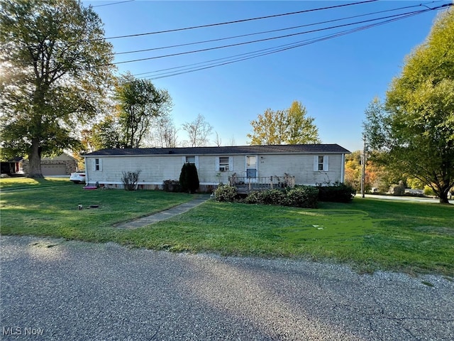 view of front facade with a front yard and a garage