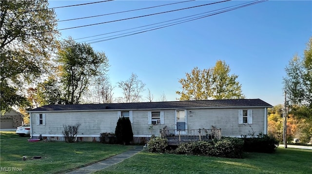 rear view of property featuring a yard