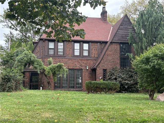 tudor home featuring a front yard