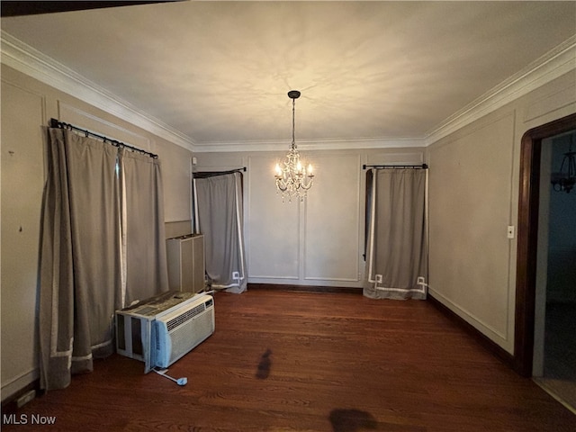 unfurnished dining area with ornamental molding, a chandelier, an AC wall unit, and dark hardwood / wood-style floors