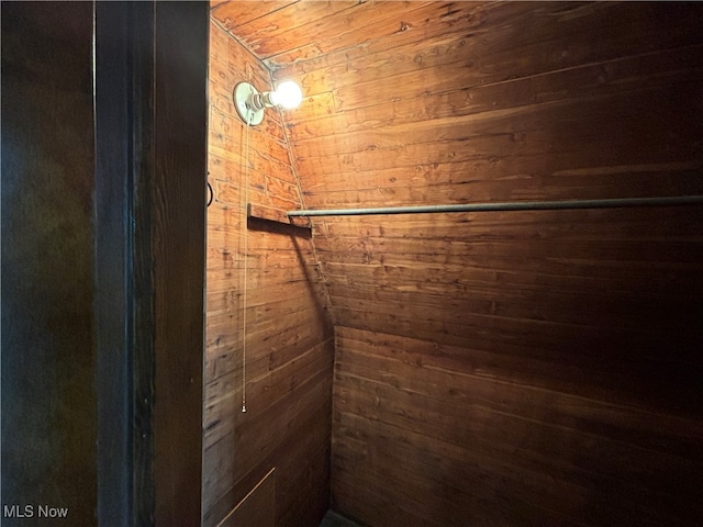 interior space featuring wood ceiling and wood walls