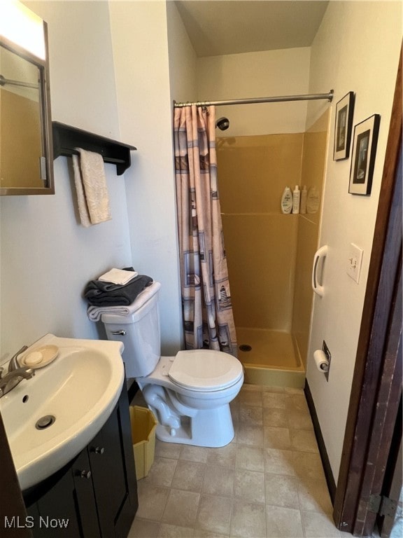 bathroom with vanity, toilet, and curtained shower