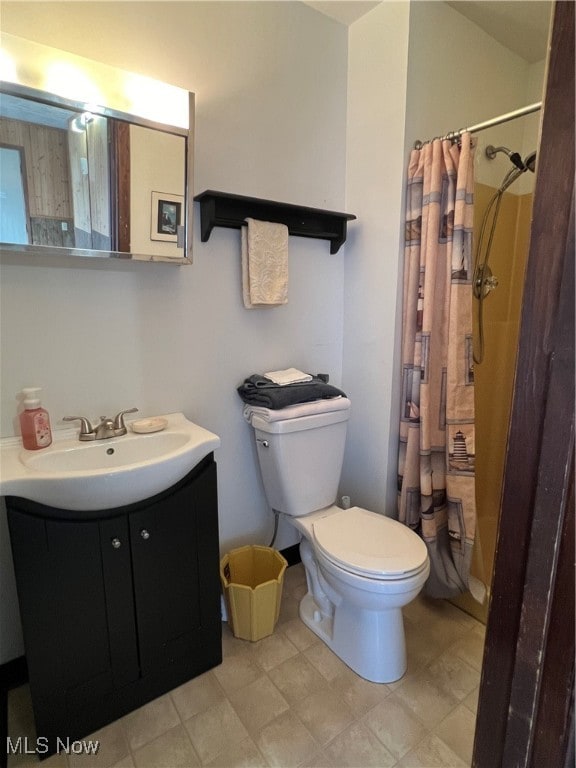 bathroom featuring toilet, a shower with curtain, and vanity