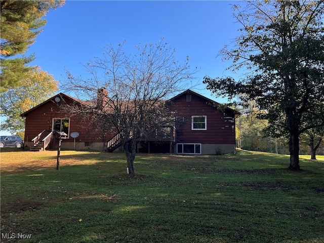 back of property featuring a lawn