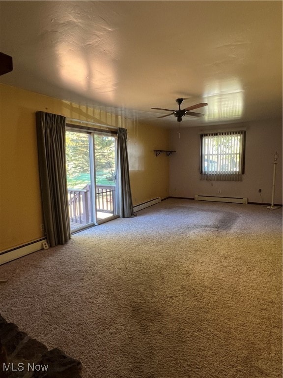 carpeted empty room featuring ceiling fan and a baseboard radiator