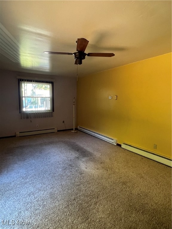 carpeted empty room featuring ceiling fan and baseboard heating