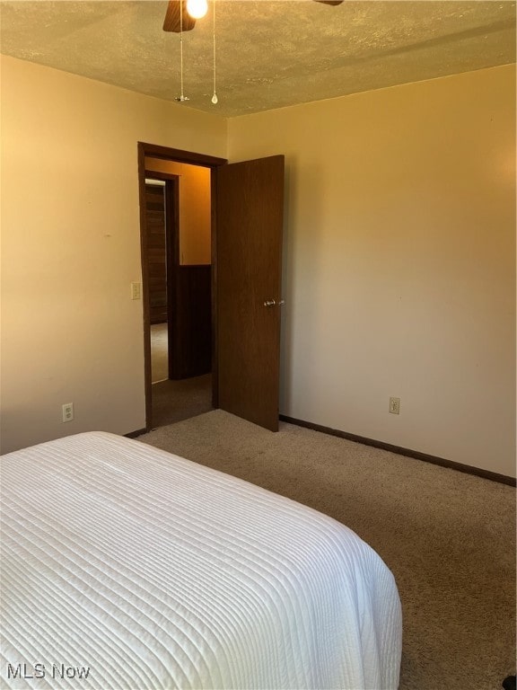 carpeted bedroom featuring a textured ceiling