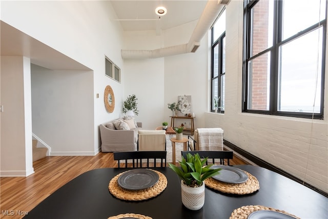 interior space featuring light wood-type flooring and brick wall