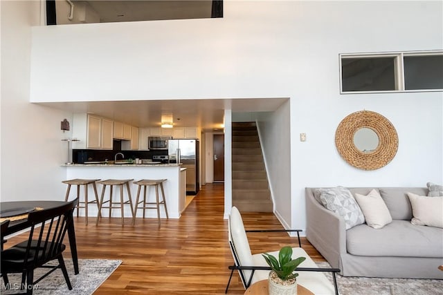 1133 W 9th St Unit 701, Cleveland, OH 44113 - living room featuring light wood-style flooring and stairway