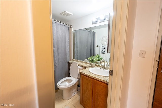 bathroom with curtained shower, vanity, toilet, and tile patterned floors