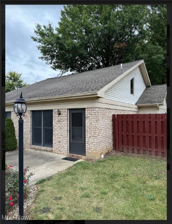 rear view of property with a patio area and a yard