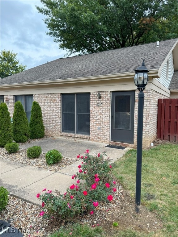 exterior space featuring a lawn and a patio area