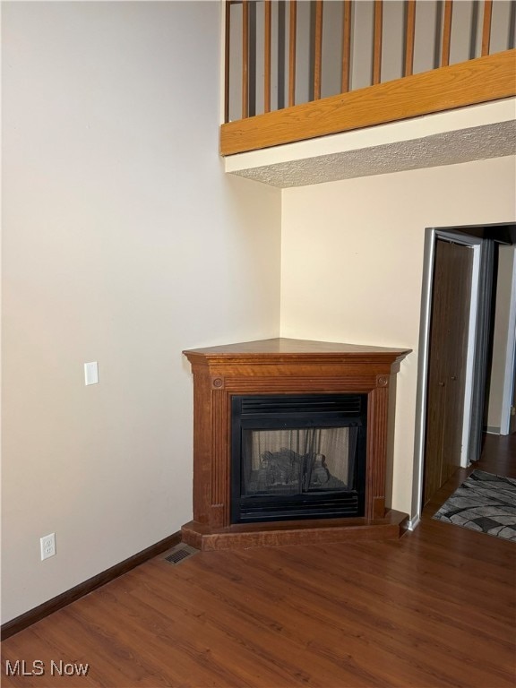 interior details with hardwood / wood-style flooring and a multi sided fireplace