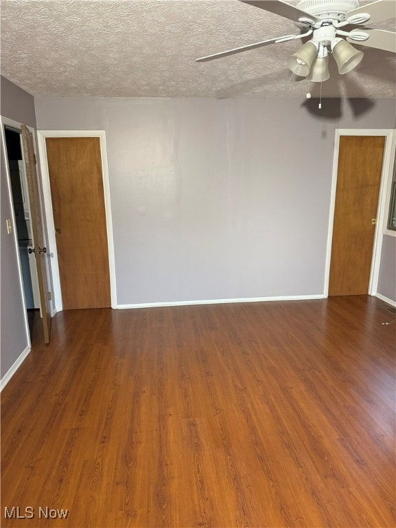 spare room with wood-type flooring, ceiling fan, and a textured ceiling