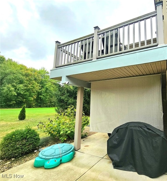 view of patio with a balcony and a grill