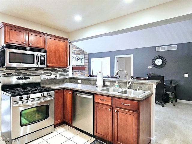 kitchen featuring sink, lofted ceiling, kitchen peninsula, light colored carpet, and appliances with stainless steel finishes