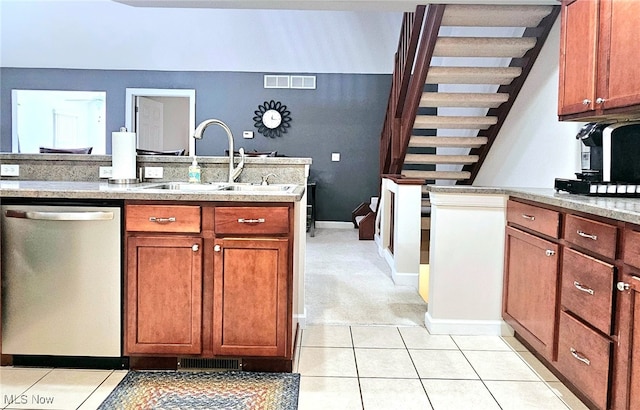 kitchen featuring light tile patterned flooring, sink, and stainless steel dishwasher