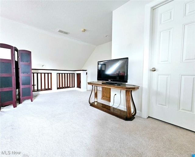 carpeted living room with lofted ceiling