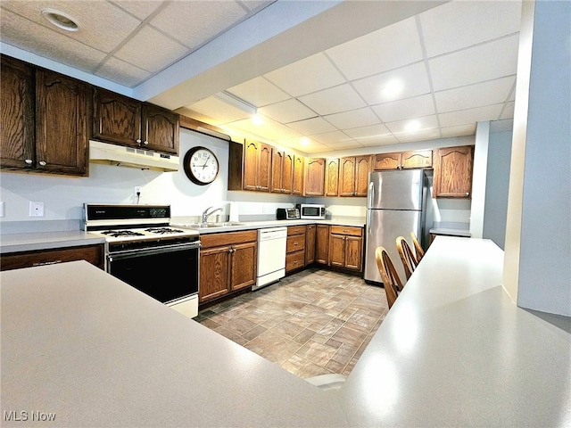 kitchen featuring a drop ceiling, appliances with stainless steel finishes, and sink