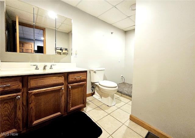 bathroom featuring vanity, a paneled ceiling, and toilet