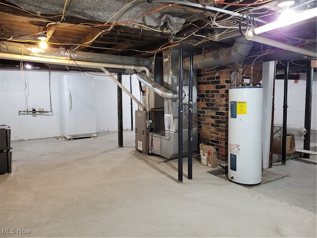 basement featuring electric water heater and white refrigerator