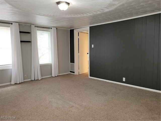 carpeted spare room with a textured ceiling