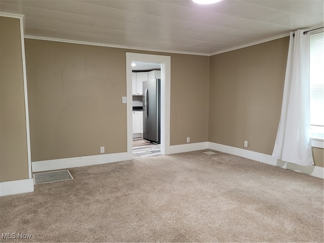 carpeted empty room featuring ornamental molding