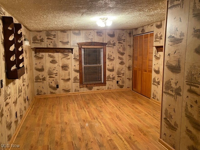 spare room featuring a textured ceiling and hardwood / wood-style flooring