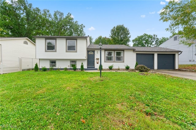 split level home featuring a garage and a front lawn