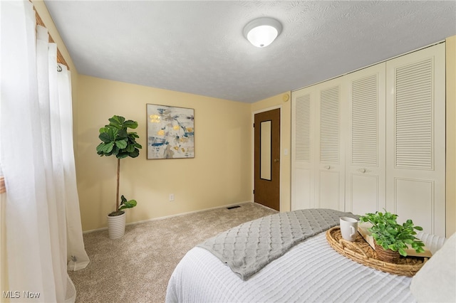 carpeted bedroom with a textured ceiling