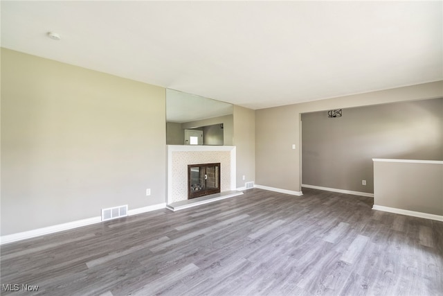 unfurnished living room with wood-type flooring