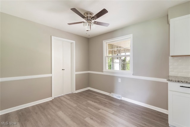 unfurnished room with ceiling fan and light hardwood / wood-style flooring