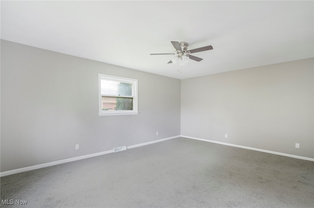 empty room featuring ceiling fan and carpet flooring