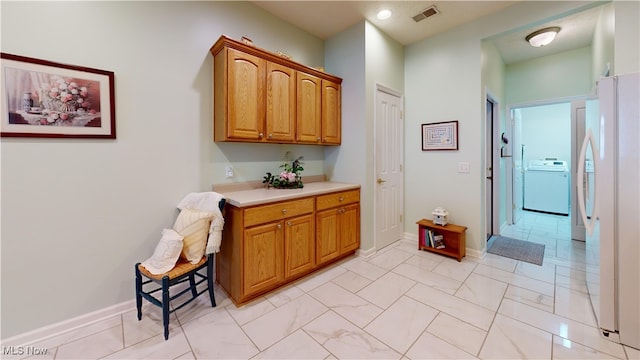 bathroom featuring washer / clothes dryer and vanity