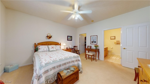 bedroom with ensuite bath, ceiling fan, and light colored carpet