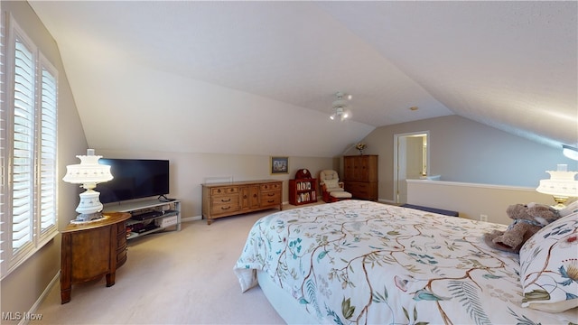 carpeted bedroom with vaulted ceiling