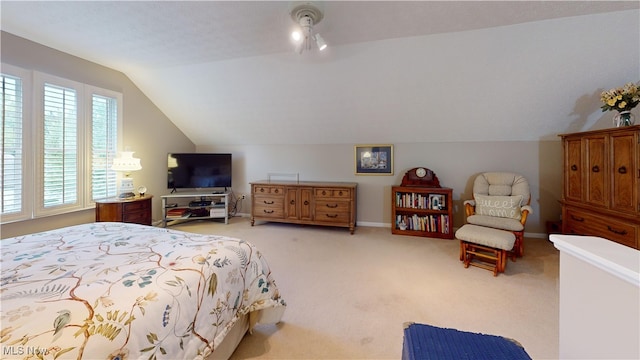 carpeted bedroom with vaulted ceiling