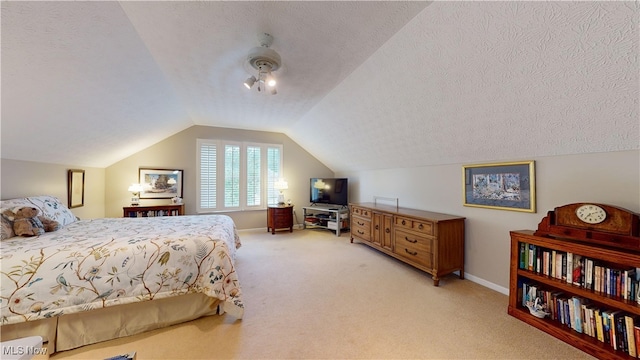 bedroom with a textured ceiling, lofted ceiling, and light carpet