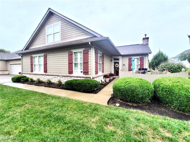 view of front facade with a front yard and a garage