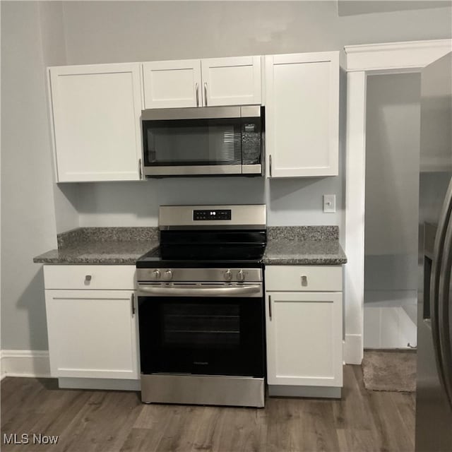 kitchen with white cabinetry, dark hardwood / wood-style flooring, and stainless steel appliances