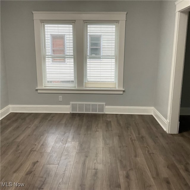 spare room with dark hardwood / wood-style flooring