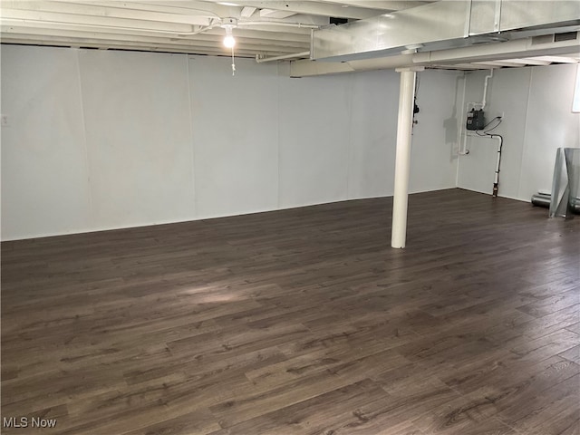 basement with dark hardwood / wood-style floors