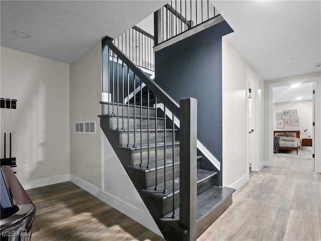 stairs with wood-type flooring