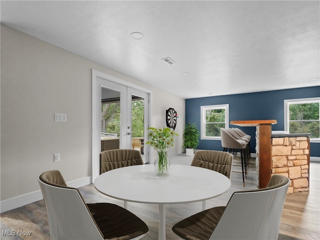 dining space featuring french doors and hardwood / wood-style flooring