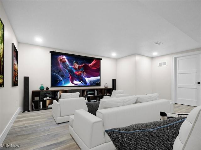 cinema room with light hardwood / wood-style floors