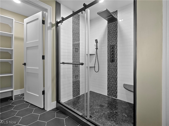 bathroom featuring tile patterned flooring and a shower with shower door