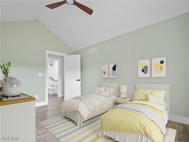 bedroom featuring hardwood / wood-style floors, ceiling fan, ensuite bathroom, and high vaulted ceiling